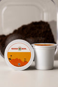 Close-up image of two Bodega Bean Co. classic coffee pods